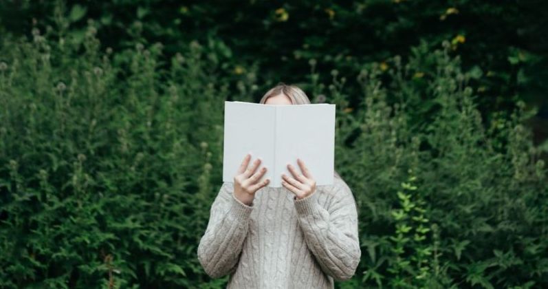 Reading a book in the forest